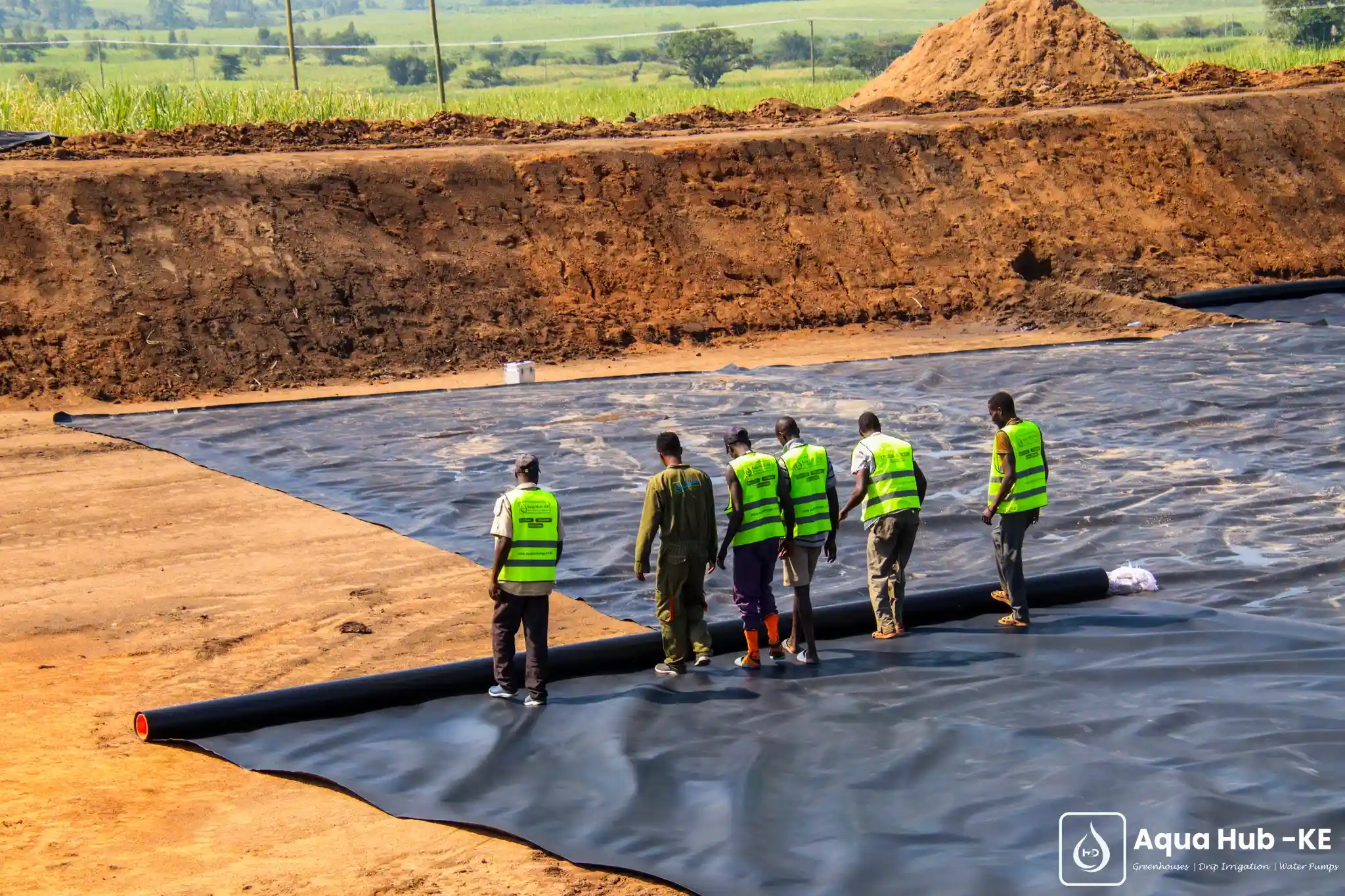 Rolling out a dam liner for a reservoir